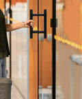 Double Sided Push Pull Door Handles In Black Finish For Sliding Doors And Glass Panels installed on glass door