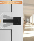 4 Pack Black Dummy Door Levers For Non Turning Interior Doors mounted on a white panel in a sunlit corridor