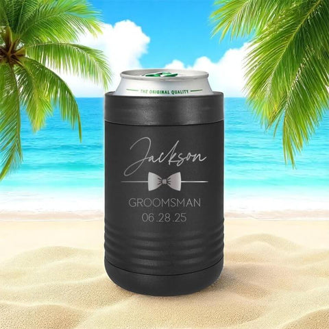 Custom Engraved Stainless Steel Can Cooler For 12 Oz And 16 Oz Cans, Vacuum Insulated With Anti Slip Grip, Keeps Drinks Ice Cold For Hours, Perfect Wedding Party Gift For Groomsmen And Bridesmaids, For The Whole Crew, Black, on a beach setting.