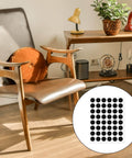 Living room with wooden chair and table, inset image showing 48 Pack Felt Pads for Furniture and Cabinet Doors, 1/2 Inch Black Round Self Adhesive Protectors