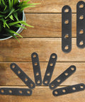 12 PCS 2.99'' x 0.63'' Stainless Straight Flat Brackets, Black Flat Metal Brace Bracket, displayed on a wooden surface
