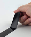 Hand holding Heavy Duty Waterproof Double Sided Foam Mounting Tape Half Inch By Eighteen Feet Black For Home Office Car And LED Strip Lights