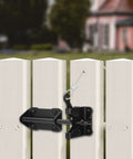 Close-up of heavy duty gate latch with gravity lever self locking wire operated release on white vinyl fence