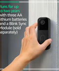 Hand installing Video Doorbell Latest Model With Head To Toe HD View With Night Vision Two Year Battery Life Easy Setup Battery Powered Smart Doorbell For Home Security Sync Module Not Included Add On Black on wall
