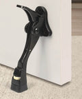 Mounted black kick down door stopper on white door, heavy duty kickdown door stop, adjustable door stoppers, one touch kick down stopper 4 inch 1 pack