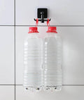 Kitchen Utensil Hanger with 6 Hooks, 2 Pack Under Cabinet Utensil Holder holding two water bottles on a tile wall