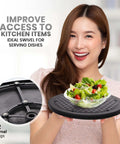 Woman holding 10 Inch Lazy Susan Turntable Organizer with salad, black durable plastic, smooth 360 rotation, ideal for serving dishes.