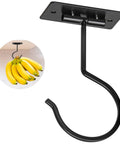 Ceiling-mounted black metal banana hanger with bananas shown hanging, designed for fruit storage in kitchens.