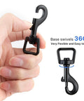 Hand holding metal heavy duty swivel snap hook, black zinc alloy, 360-degree rotation, part of 20Pcs Bolt Snap Hooks Set For Dog Leash Clips And DIY Projects.