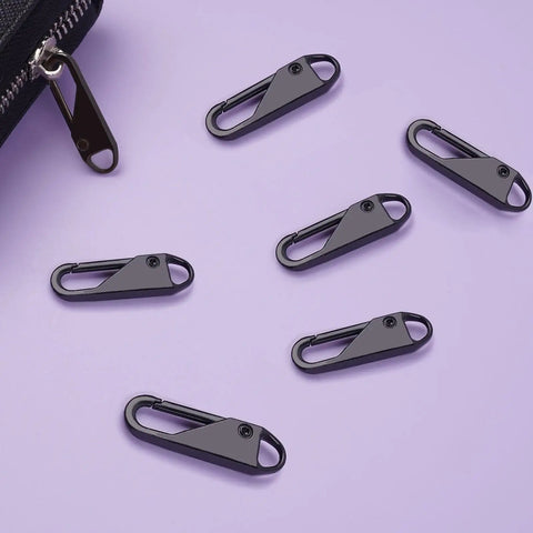 Six Piece Metal Zipper Pull Replacement Set For Luggage Suitcases Backpacks Jackets Purses And Handbags Clip On No Tools Needed Durable Black Great For Travel And Everyday Use showing six black clip-on zipper pulls on a purple background next to luggage.
