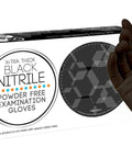 Hand wearing Black Nitrile Gloves 4 Mil Powder Free Latex Free Food Safe Large 100 Count next to box packaging