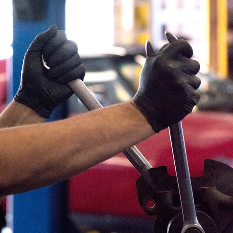 Mechanic using wrench wearing Black Nitrile Gloves 6 Mil Latex Free Powder Free Mechanics Automotive XL