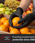 Person wearing Black Nitrile Gloves 5 Mil Silicone Free for Food Prep and Cleaning, Disposable, handling oranges in a market.