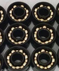 100-Pack Skateboard/inline Skate/Roller Hockey Black Open Bearings - Bronze Cage 8x22x7mm displayed in a close-up view.