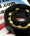 Close-up of 8-Pack Skateboard Black Open Bearings - Bronze Cage 8x22x7mm showing bronze balls inside black casing.
