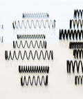 114 Piece Black Oxide Finish Compression Spring Assortment With 29 Sizes In A PP Storage Case Including Chart On Lid For Quick Identification Pro Grade Spring Steel Factory Direct For Tough Mechanical Projects