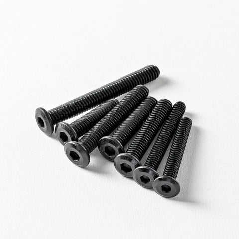 Pack of Quarter Twenty Flat Head Hex Socket Cap Screws Bolts Three Quarter Inch Black Oxide 304 Stainless Steel on white surface