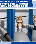 Pressure tanks with hose connections and gauges in industrial setting with durable black paint coating.