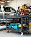 Heavy Duty 2 Shelf Plastic Utility Service Cart On Wheels With 550 Lb Capacity And 45 X 25 Inch Size Rugged Rolling Work Cart For Warehouse Garage School And Office Corrosion Resistant And Built Tough Black in garage setting with tools and storage boxes