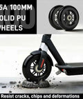 Pro Kick Scooter Replacement Wheels 100mm Pair installed on a scooter over rocky surface, showing high-speed smooth bearings, black color.
