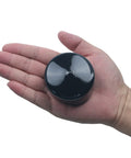 2 And A Half Inch Rubber Cap For Round Holes Flexible Black PVC End Caps shown in hand for scale.