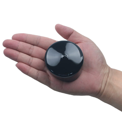 2 And A Half Inch Rubber Cap For Round Holes Flexible Black PVC End Caps shown in hand for scale.