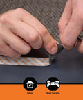 Hands tearing heavy duty mounting tape that sticks like a champ with double sided adhesive and instant hold, one inch by sixty inches