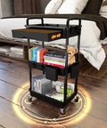 Side view of a black 3 Tier Rolling Utility Cart With Drawer On Wheels For Kitchen Bathroom Living Room And Office Must Have Space Saving Multi Functional Storage Organizer Black By REBECAT, shown in a bedroom.