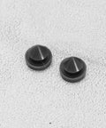 Close-up view of 100 Pcs Rubber Door Silencers For Metal Frame Doors Anti Slam Hinge Outlet Cushions on grey surface