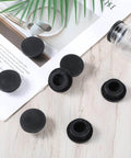 10 Pack 1 Inch Black Rubber Hole Plugs Silicone Round Grommets for Wiring on wooden surface