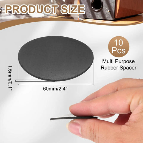 Close-up of a hand holding a black rubber spacer washer, 60mm diameter and 1.5mm thick, part of a 10-pack set for DIY use.