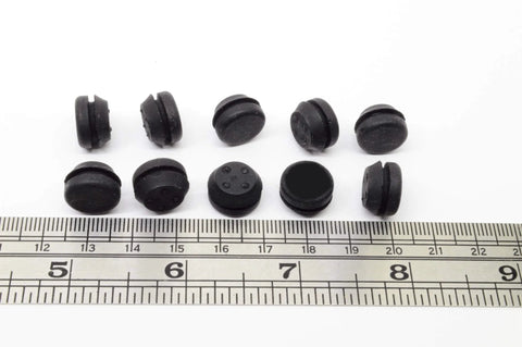 Black SBR rubber push-in bumpers, 1/2 inch diameter, 1/8 inch height, next to ruler, pack of six, surface protection, withstands -20 to 180°F.