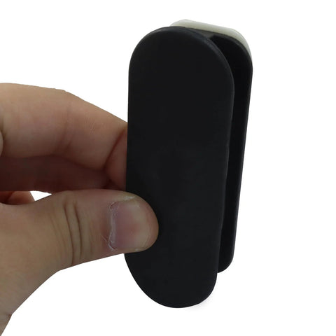 Close-up of hand holding Two Pack Self Adhesive Pull Handles For Cabinets Doors Drawers Windows Closets And Clothing Boxes Black Easy Install