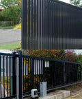 Sliding gate with hardened steel panels using 2Pack Slide Gate Guide Roller with C Post Welded Bracket for smooth motion and alignment.