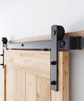 8.2 FT Heavy Duty Sturdy Sliding Barn Door Hardware Kit, Black, mounted on wooden door, showing I Shape Hanger