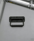 Installed view of spring loaded chest handle with rubber grip on metal surface