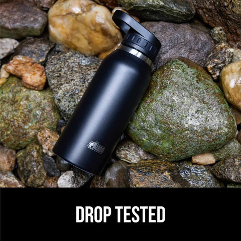 Beast Mode Heavy Duty Stainless Steel Water Bottle 40 Oz Insulated Tumbler With Leakproof Flip Straw Lid on rocks