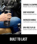 Person holding Beast Mode Heavy Duty Stainless Steel Water Bottle 40 Oz Insulated Tumbler in car, showing dent-resistant and leakproof lid.