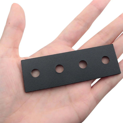 Black Carbon Steel Barn Door Track Splice Piece 80mm metal splice plate repair fastener shown in hand with four countersunk holes