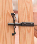 Black finish Built Tough Post Mount Gate Latch with Self Latching Fingertip Release installed on wooden garden fence for safety