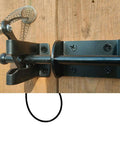 Close-up of Self Locking Gate Latch For Outdoor Fences In Black Steel With Automatic Gravity Lever Lock on wooden gate.