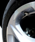 Close-up of a universal tire valve cap installed on a car wheel, part of the 30 Pack Universal Tire Valve Caps With O Ring For Cars SUVs Trucks.