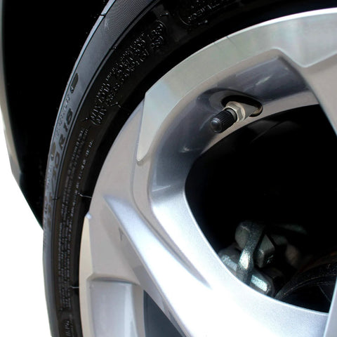 Close-up of a universal tire valve cap installed on a car wheel, part of the 30 Pack Universal Tire Valve Caps With O Ring For Cars SUVs Trucks.