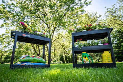 32 Inch Tub Storage Cart With Two Shelves Black Built For Maximum Capacity Ergonomic Top Handle And Super Handy Maneuver Four Swivel Casters With Two Locking Brakes Molded Plastic Shelves And Legs Won't Stain Scratch Dent Or Rust shown in a garden setting