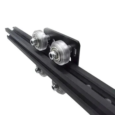 Close-up of Black 2020 Aluminum Extrusion V-Slot Gantry Plate Set w White Wheels on rail