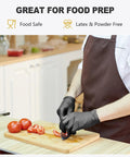 Person wearing Black Vinyl Disposable Gloves Medium Size Latex Free And Powder Free Food Grade Gloves For Cleaning Cooking And Food Preparation