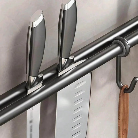 Close-up of Modern Kitchen Utensil Rack, Black Wall-Mounted Hanging Rod with 6 Movable Hooks holding knives and a wooden utensil.