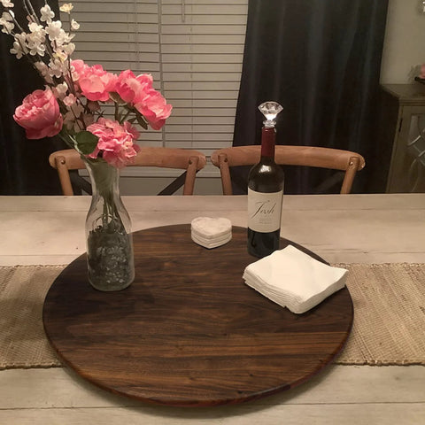 24 Inch Black Walnut Wood Lazy Susan Round Turntable for tabletop use, featuring a vase with flowers, wine bottle, and coasters.