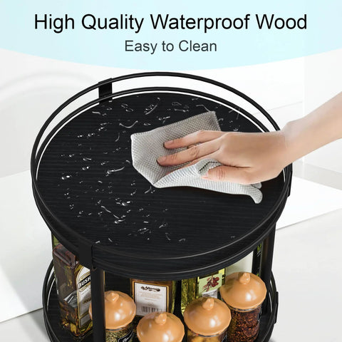 Two Tier Wooden Lazy Susan Spice Rack With 360 Degree Rotation, black finish, showing a hand wiping the waterproof surface.