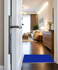 Blue adhesive sticky floor mat 24x36 inches at entryway, peel and stick tacky pad for construction sites, labs, cleanrooms, hospitals, and sports shoes.